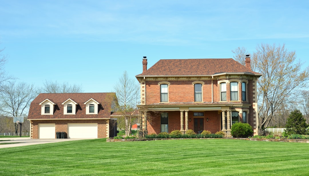 A beautiful, modern suburban home with a manicured lawn on a bright, sunny day, representing a valuable real estate asset in Columbus.