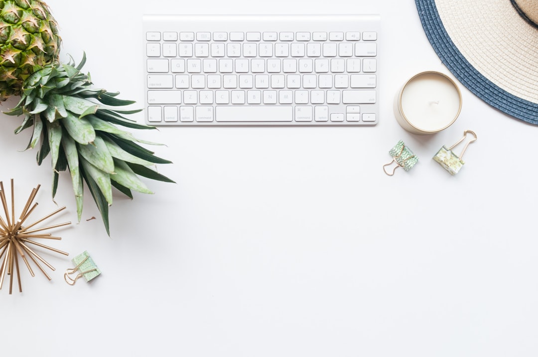 A clean, minimalist desktop with a set of house keys next to a modern calculator, symbolizing the process of calculating a home's value and equity.
