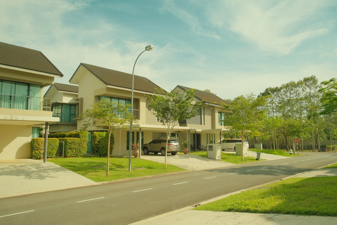 The exterior of a well-maintained suburban home with great curb appeal on a bright, sunny day, illustrating an improvement that increases sale price.