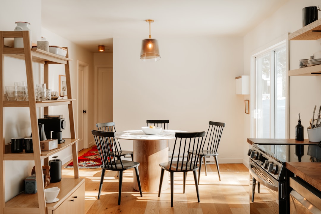 Savvy homeowner carefully reviews architectural blueprints for a kitchen remodel, representing a smart, ROI-focused home i...