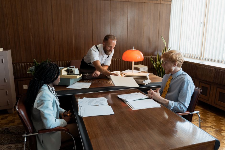 Classic, outdated Rolodex sits on a clean, modern desk, symbolizing an old way of doing business in a contemporary setting.