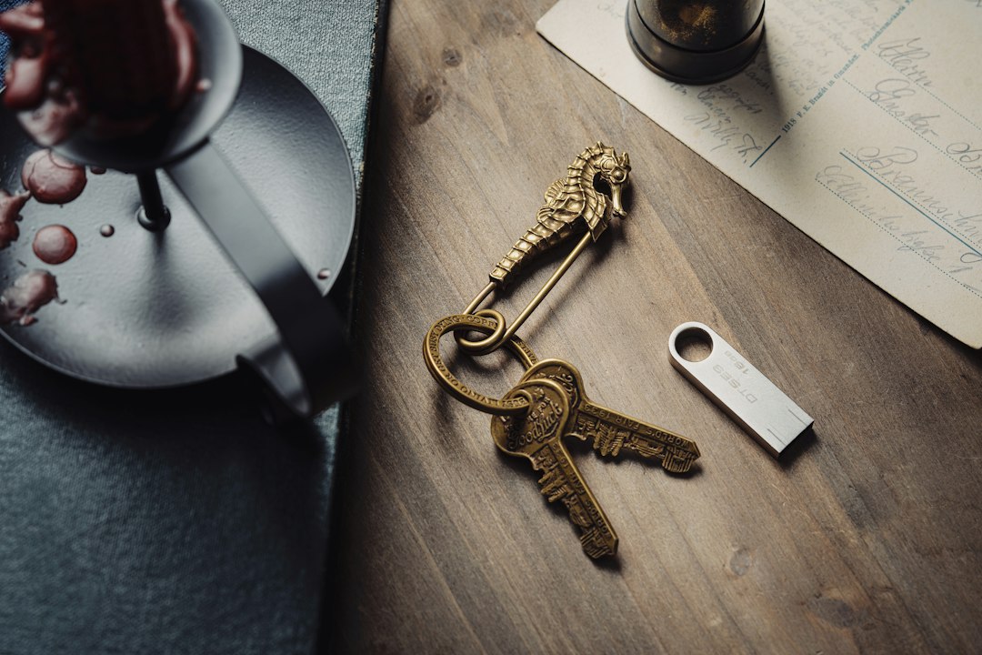 A clean, professional flat lay of a minimalist desk with a laptop and house keys, symbolizing a modern digital real estate strategy.