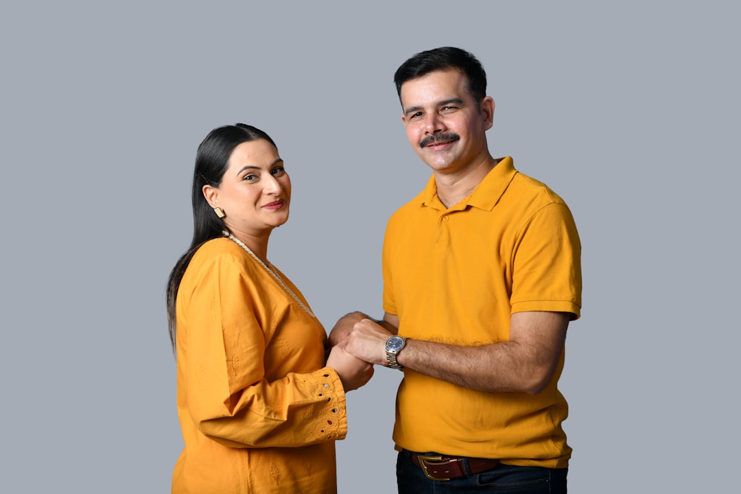 A professional real estate agent smiles while handing over house keys to a happy new homeowner, symbolizing the final step of a successful closing.