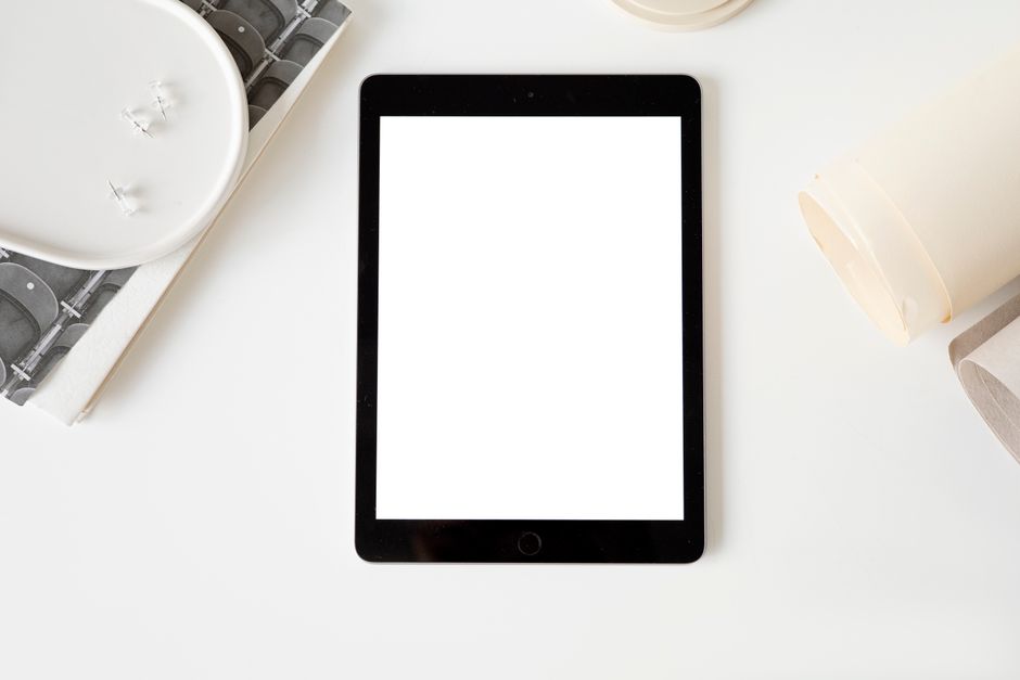 A side-by-side comparison showing a thick, old book next to a sleek, modern tablet on a clean desk, symbolizing the evolution from traditional to digital information.