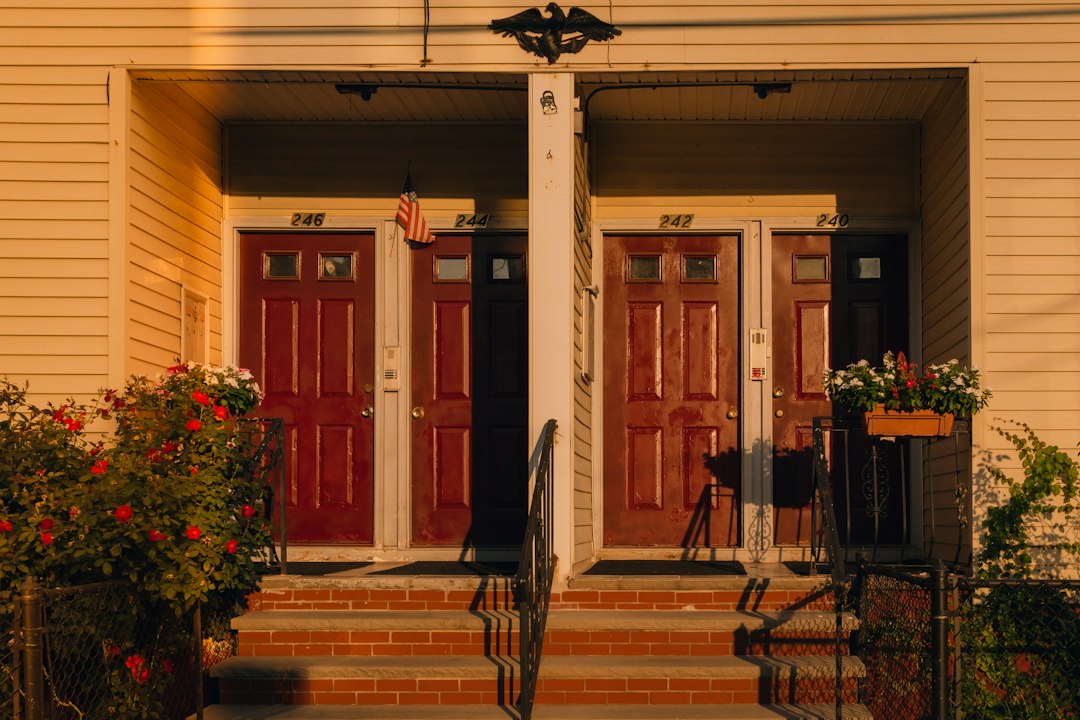 A sleek, modern front door next to a traditional, classic front door, symbolizing the choice homeowners face between a 1% and 6% real estate commission.