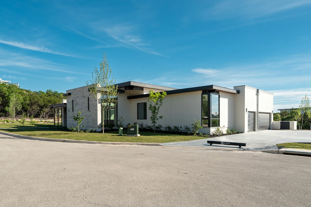Stunning exterior of a modern architectural home on a bright, sunny day, representing a prime Columbus property and the va...